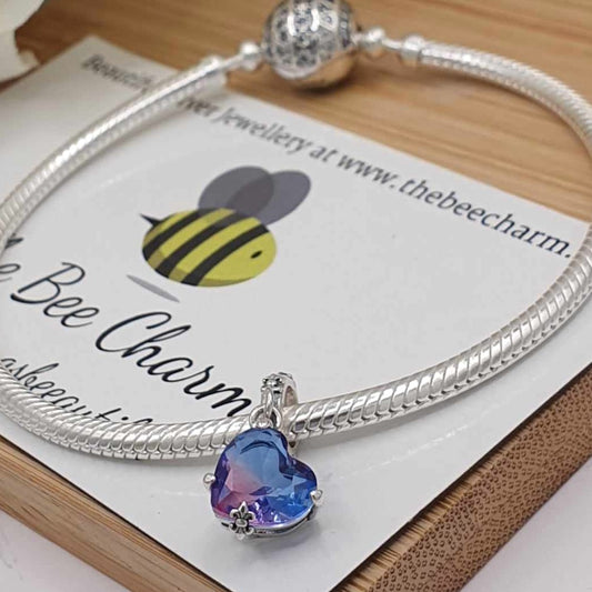 Ombre Purple Heart Charm- 925 Sterling Silver stamped & Cubic Zircons. This stunning charm features a large ombre purple heart shaped Zircon. The band is ornately decorated to match the clasps holding the heart or a necklace.