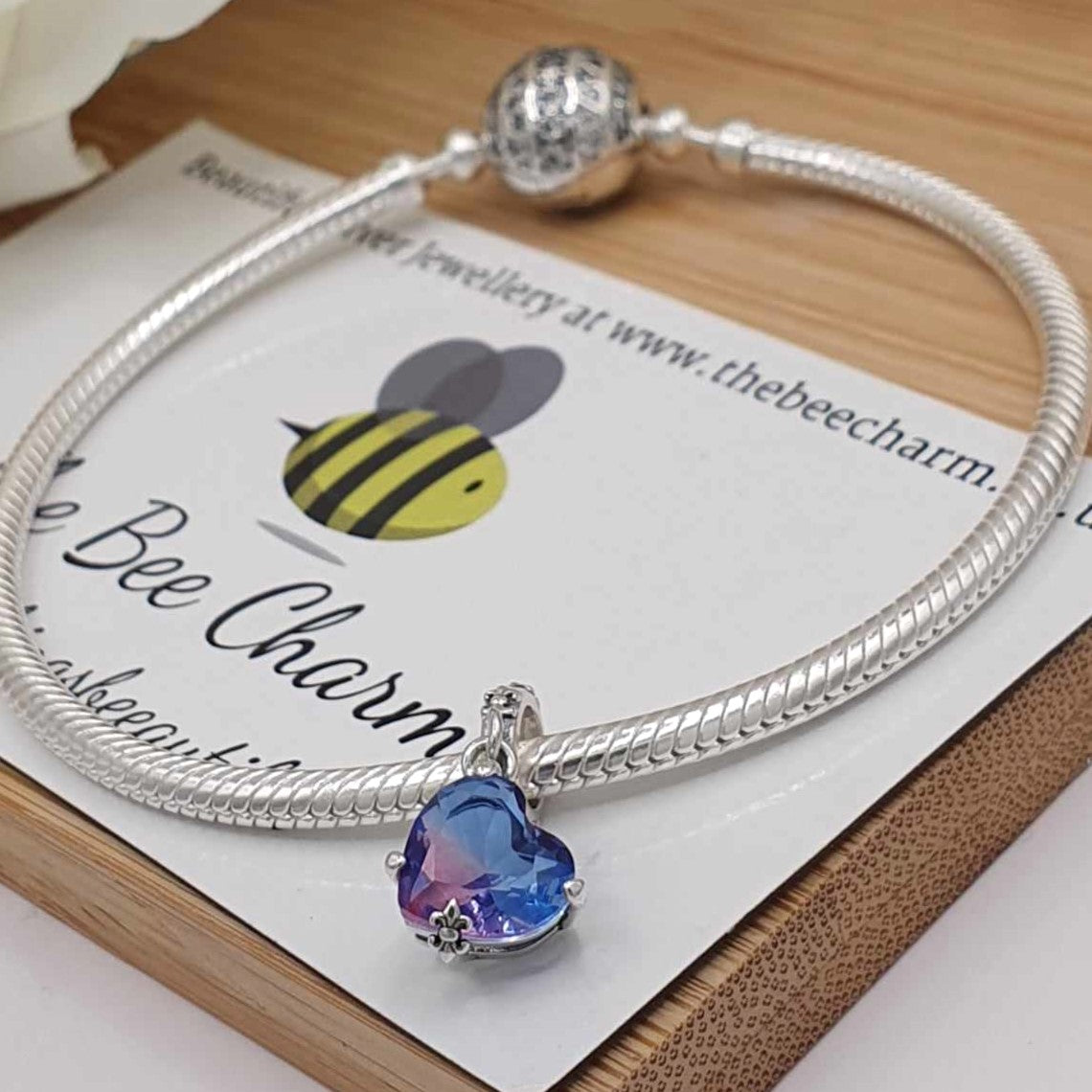 Ombre Purple Heart Charm- 925 Sterling Silver stamped & Cubic Zircons. This stunning charm features a large ombre purple heart shaped Zircon. The band is ornately decorated to match the clasps holding the heart or a necklace.