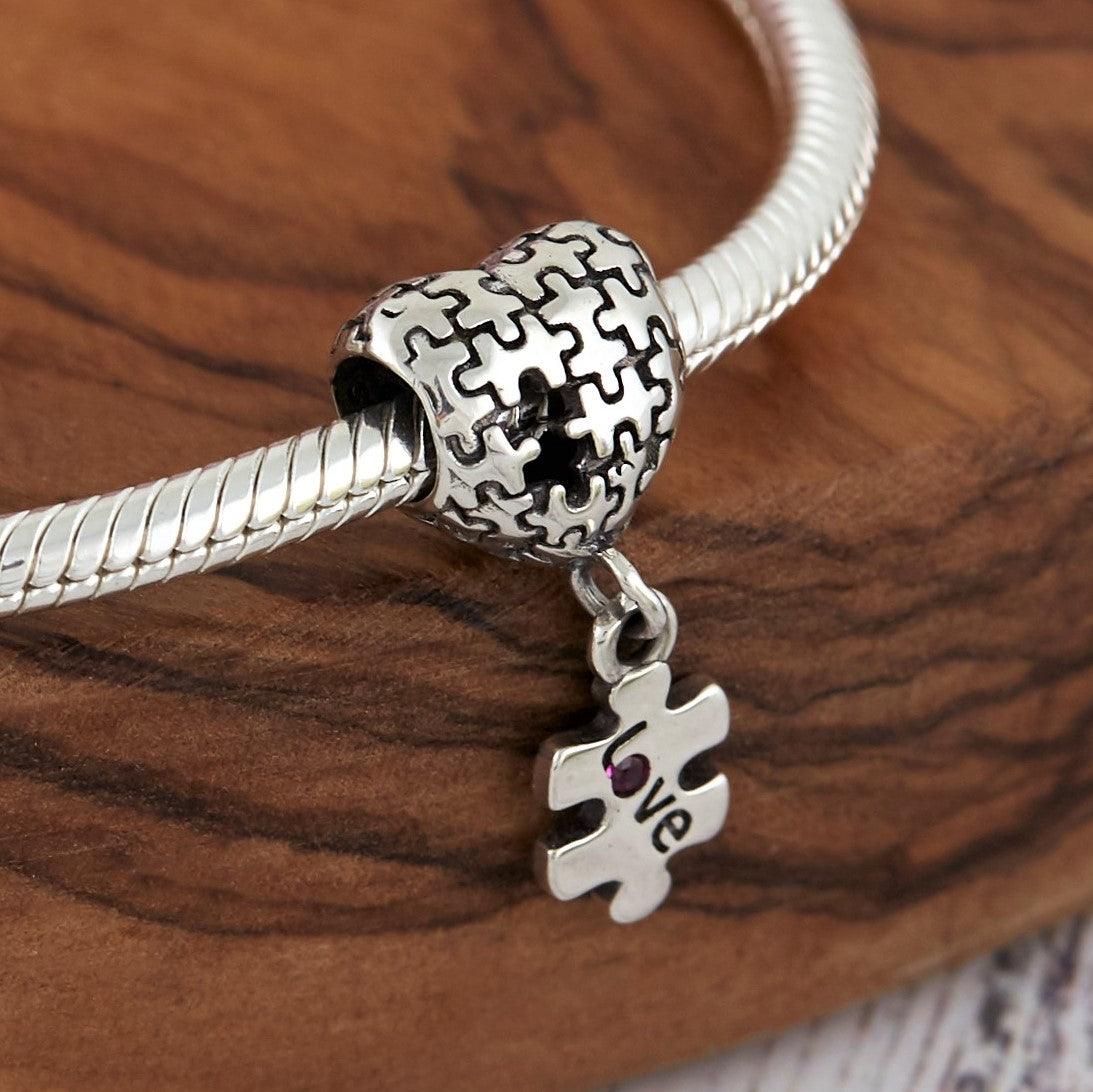 Puzzle Charm- 925 Sterling Silver, this unique Autism charm is in the shape of a heart with puzzle pieces printed into it.