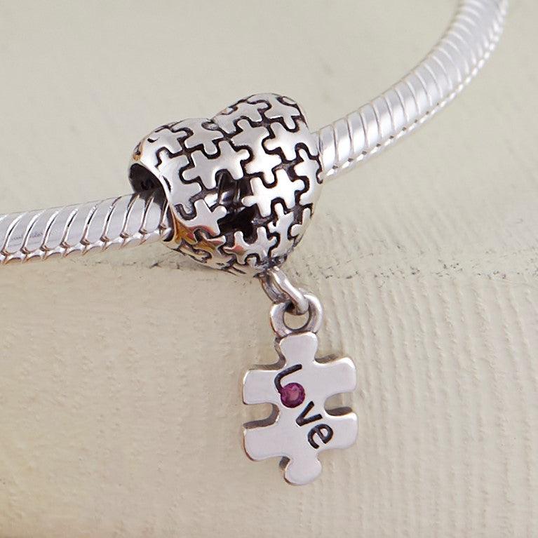 Puzzle Charm- 925 Sterling Silver, this unique Autism charm is in the shape of a heart with puzzle pieces printed into it.